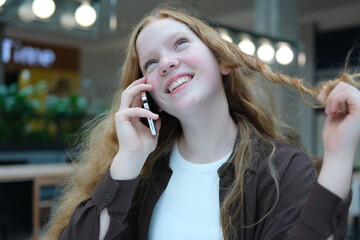 A young girl talking on the phone. Close-up of her face.