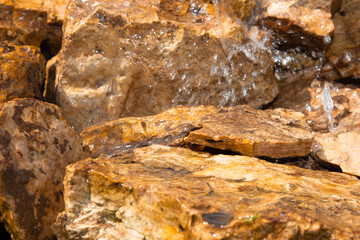 Transparent water flows over sharp stones.