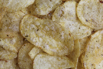 Pile of thin slices of potato chips with nori seaweed seasoning, full background, flat lay or top view