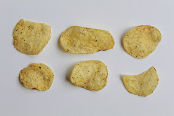 Six pieces of potato chips, isolated on white background. Thin slice of potato chip. Flat lay or top view