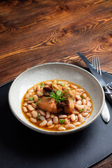 Turkey, beans, and sun-dried tomatoes stew - a hearty protein-rich dish. Traditional rural kitchen concept. A manually taken photo, not AI