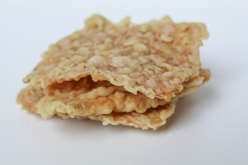 Keripik tempe or tempeh crackers, square shape. Thin slices tempeh, fried with flour dough. Isolated in white background