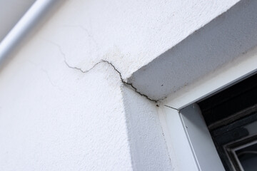 Close up of a a crack in the facade insulation cladding near the window lintel area