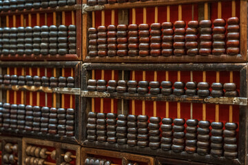 Naklejka premium Classic Chinese Abacus Collection Displayed on Wooden Shelves