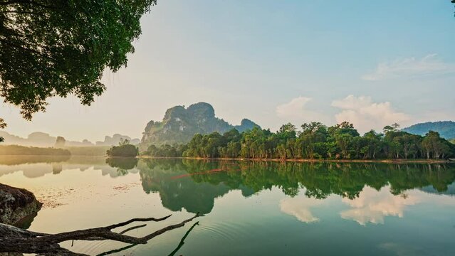 Time lapse Pastel Pink Sunrise over the swamp. Peaceful Seascape over lake Nong Thale Krabi. with Clouds and forest Reflected on Sea Water. Panoramic Horizon Coastal Landscape. Landscape Nature