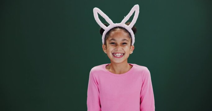 Easter, bunny and child pointing to surprise announcement, news or shock in studio mockup. Holiday, info and excited kid show crazy choice in dark background, space with fashion or costume ears