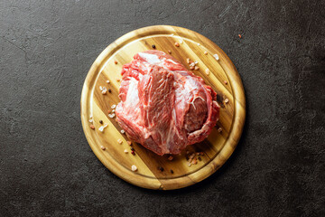 Raw beef meat on a wooden cutting board