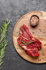 Raw beef meat on a wooden tray