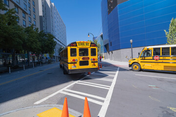Bright yellow school bus on busy Georgia Aquarium Street