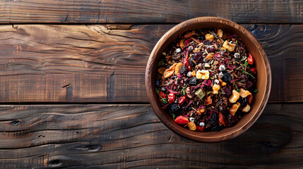 Bowl with dry fruit tea on wooden background