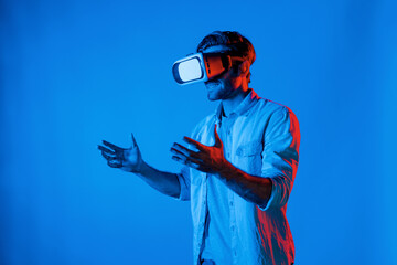 Side view of happy man holding and moving gesture while using VR goggle. Happy person using headset...
