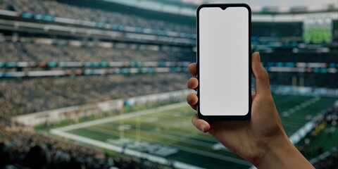Hand with smartphone at football stadium, perfect for betting, live-stream apps