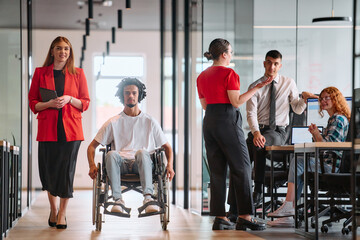 A business leader with her colleague, an African-American businessman who is a disabled person,...