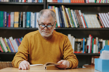 Bookish Delight A Senior Man Engrossed in Reading