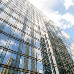 Obraz premium Modern building in the city with sunlight. Abstract texture and blue glass facade in modern office building., Retro stylized colorful tonal filter effect. 