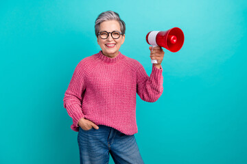 Photo of positive senior woman with short hairdo dressed pink sweater in glasses hold loudspeaker...