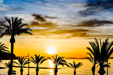 Beautiful sunset with orange sky on Aguadulce beach, Almeria, Andalucia