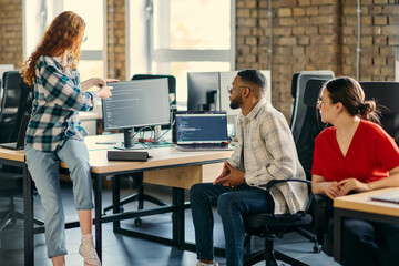 A diverse group of young business individuals congregates in a modern startup coworking center, embodying collaborative innovation and a dynamic atmosphere