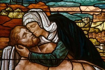 A stained-glass window depicting the Pieta. Un vitrail représentant la Piéta. Mouxy - France 
