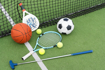A group of sports equipment on background including tennis, basketball, and soccer on a background with copy space