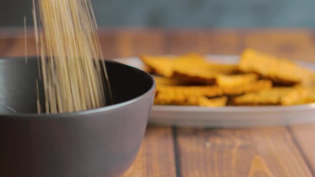 Pouring quinoa on plate to make healthy snack