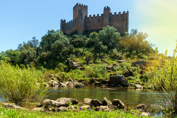 almoural castle portugal viewed from the riverbank exterior building view over riverbank