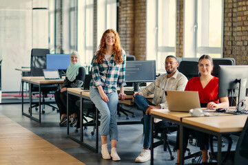 A diverse group of young business individuals congregates in a modern startup coworking center, embodying collaborative innovation and a dynamic atmosphere