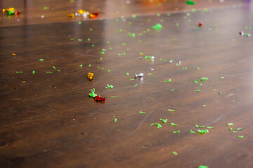 The day after the party. Empty room with confetti and balloons on the floor.