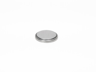 CR2032 button cell battery close up on a white background.