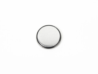 One single CR2032 button cell battery on a white background. Close up.