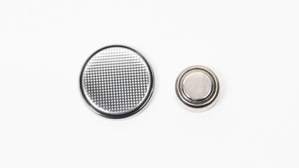LR44 and CR2032 button cell batteries on a white background. Close up.