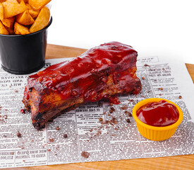 Succulent bbq pork ribs with dipping sauce and wedges