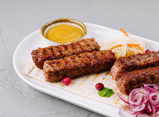 Grilled kebabs platter with sauces and salad