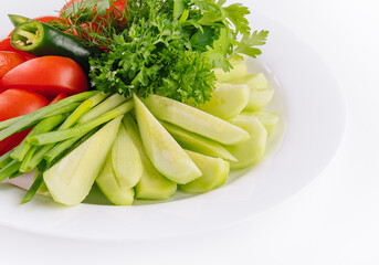 Vegan plate of fresh sliced cucumbers, green onions and cherry tomatoes