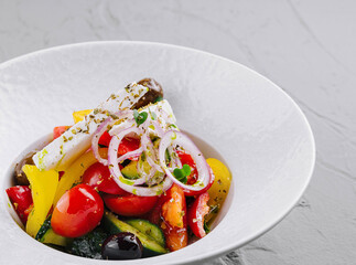 Fresh greek salad in white bowl