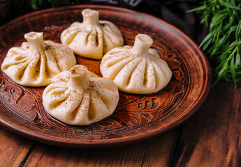 Georgian khinkali on traditional plate