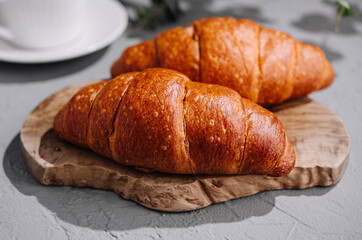 Fresh croissants and coffee on table