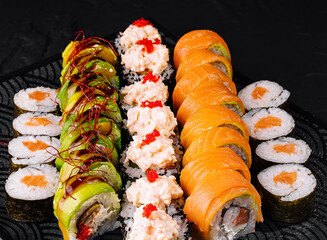 Assorted sushi platter on black background