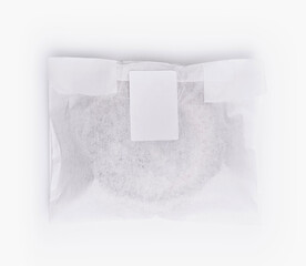Sealed paper bag with blank label on white background