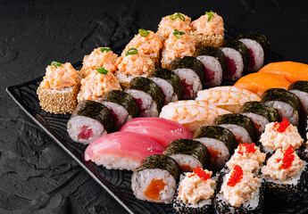 Assorted sushi platter on a black slate