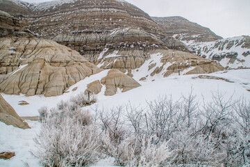 Winter clings to the hoodoos as spring arrives in the badlands. Drumheller Alberta, Canada.