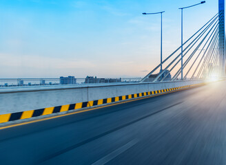 The bridge island of Koh Norea with sun set in Phnom Penh city, the empty road 