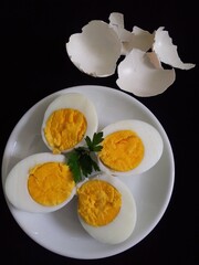 Boiled eggs sliced and garnished with parsley 