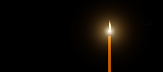 ํYellow candle burns isolate on black background, copy space