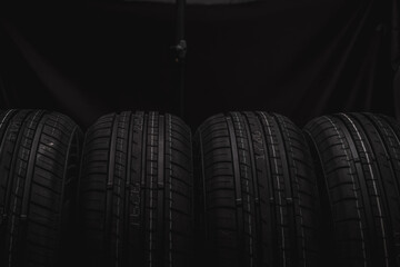 Car tires on a black background. Black tires on a black background.