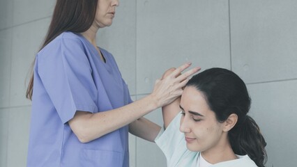 Doctor doing physical therapy on young female patient from office syndrome