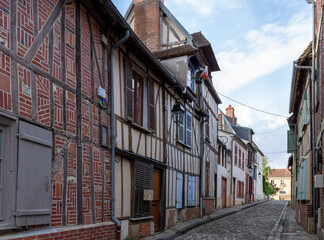 Beautiful street with traditional French buildings with wooden beams and colorful, surroundings of...