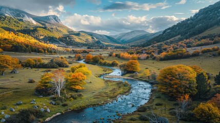A river runs through a valley with trees on both sides. The trees are orange and yellow, and the sky is blue. The scene is peaceful and serene, with the river flowing calmly through the valley - Powered by Adobe