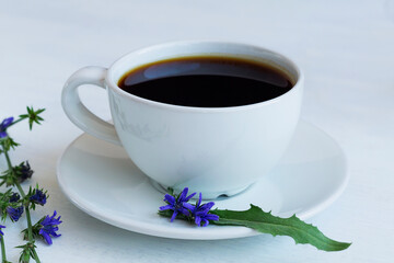 delicious chicory drink in white Cup decorated chicory flowers. hot and healthy drinks. coffee substitute. copy space.