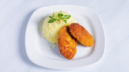 Chicken cutlets with rice on plate top view